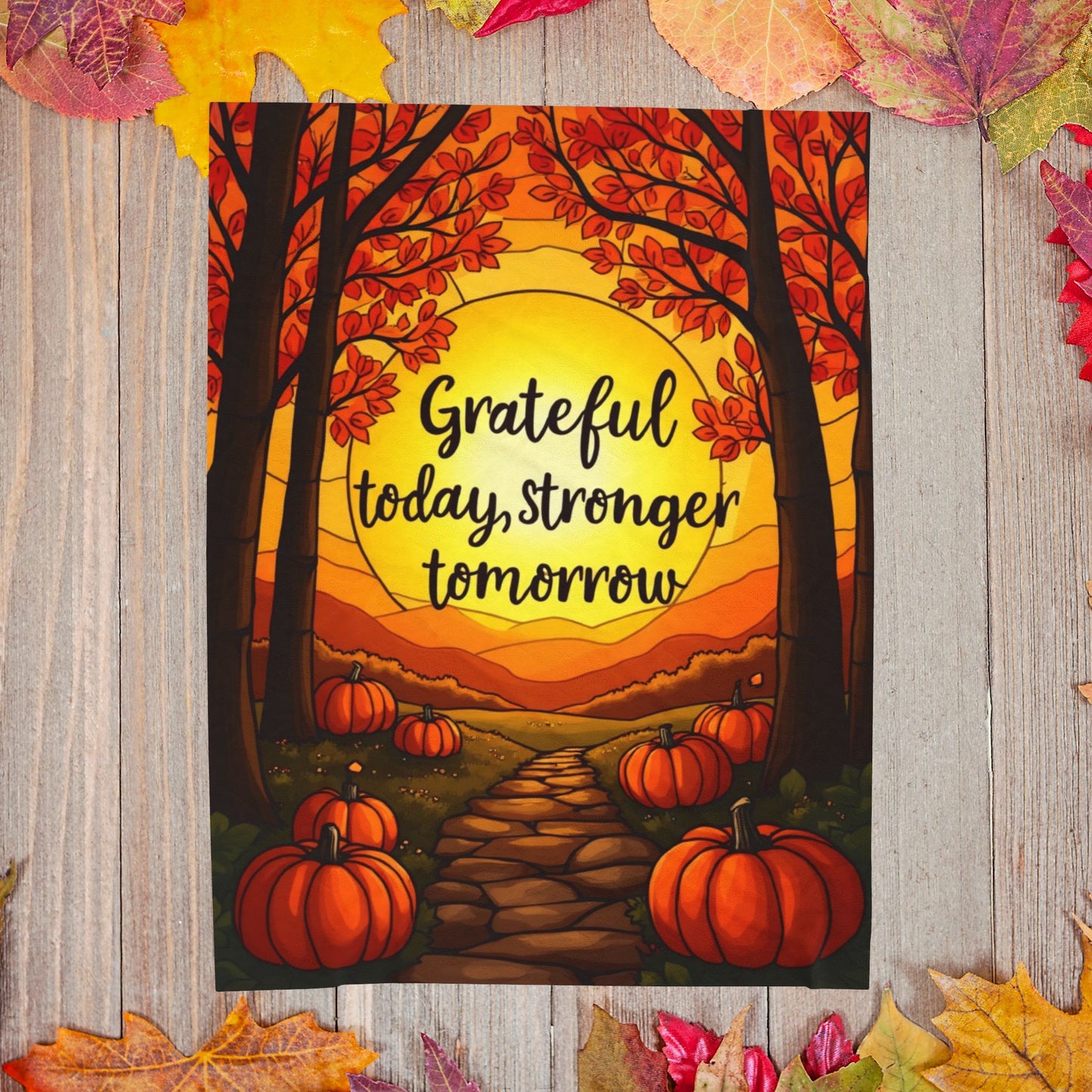 Motivational blanket with “Grateful Today, Stronger Tomorrow,” positive fall mindfulness message.