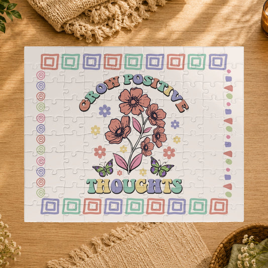 Jigsaw puzzle with floral design and 'Grow Positive Thoughts' text on a white background