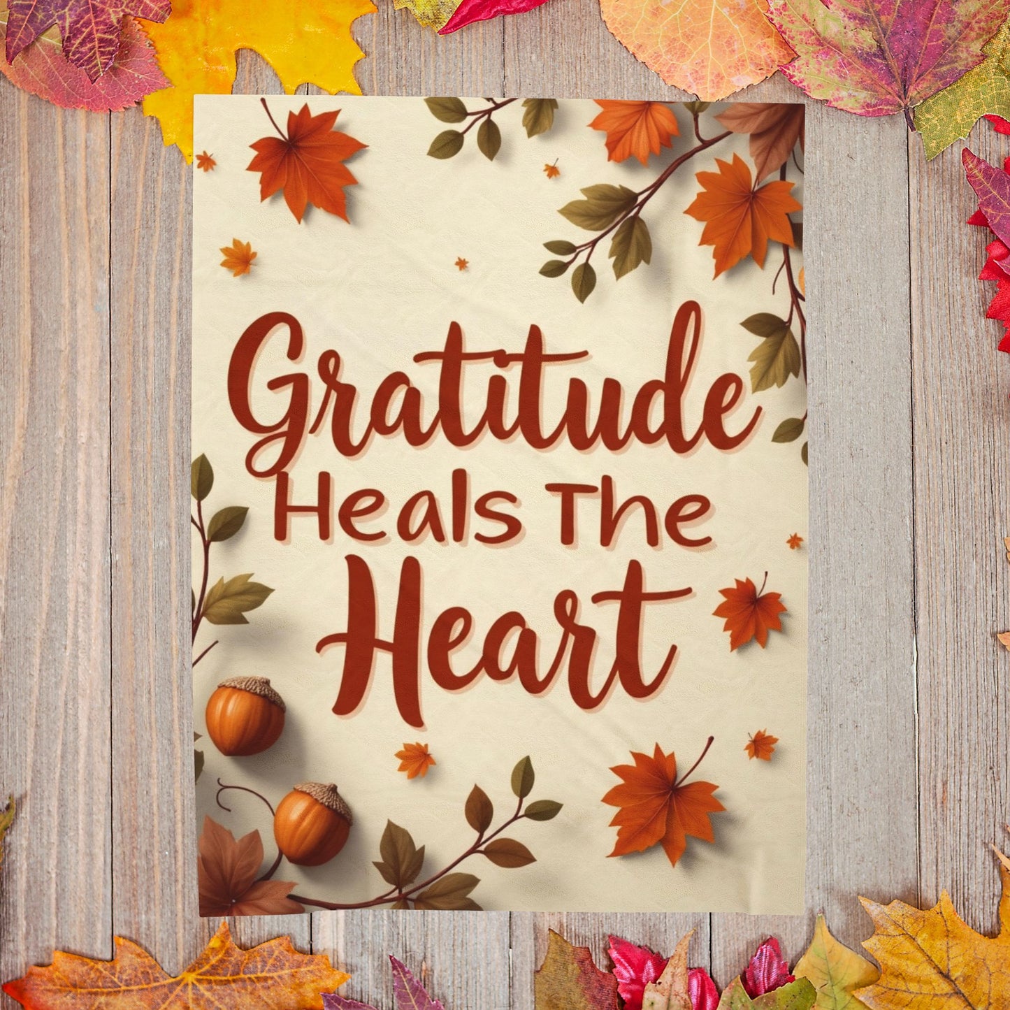 Cozy blanket reading “Gratitude Heals the Heart,” autumn mindfulness design promoting warmth and peace.