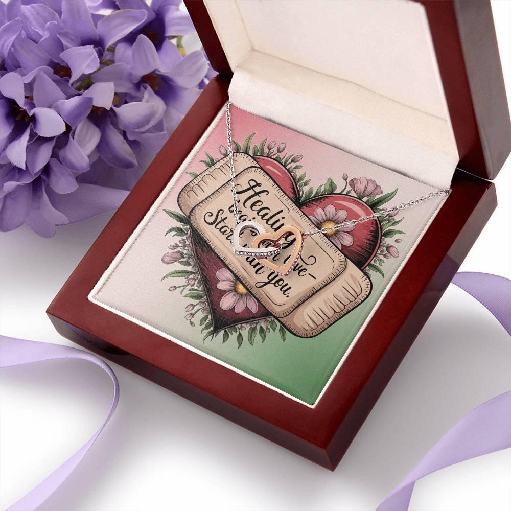 Shop our premium healing begins with love interlocking hearts necklace from MySisterIsASurvivor.