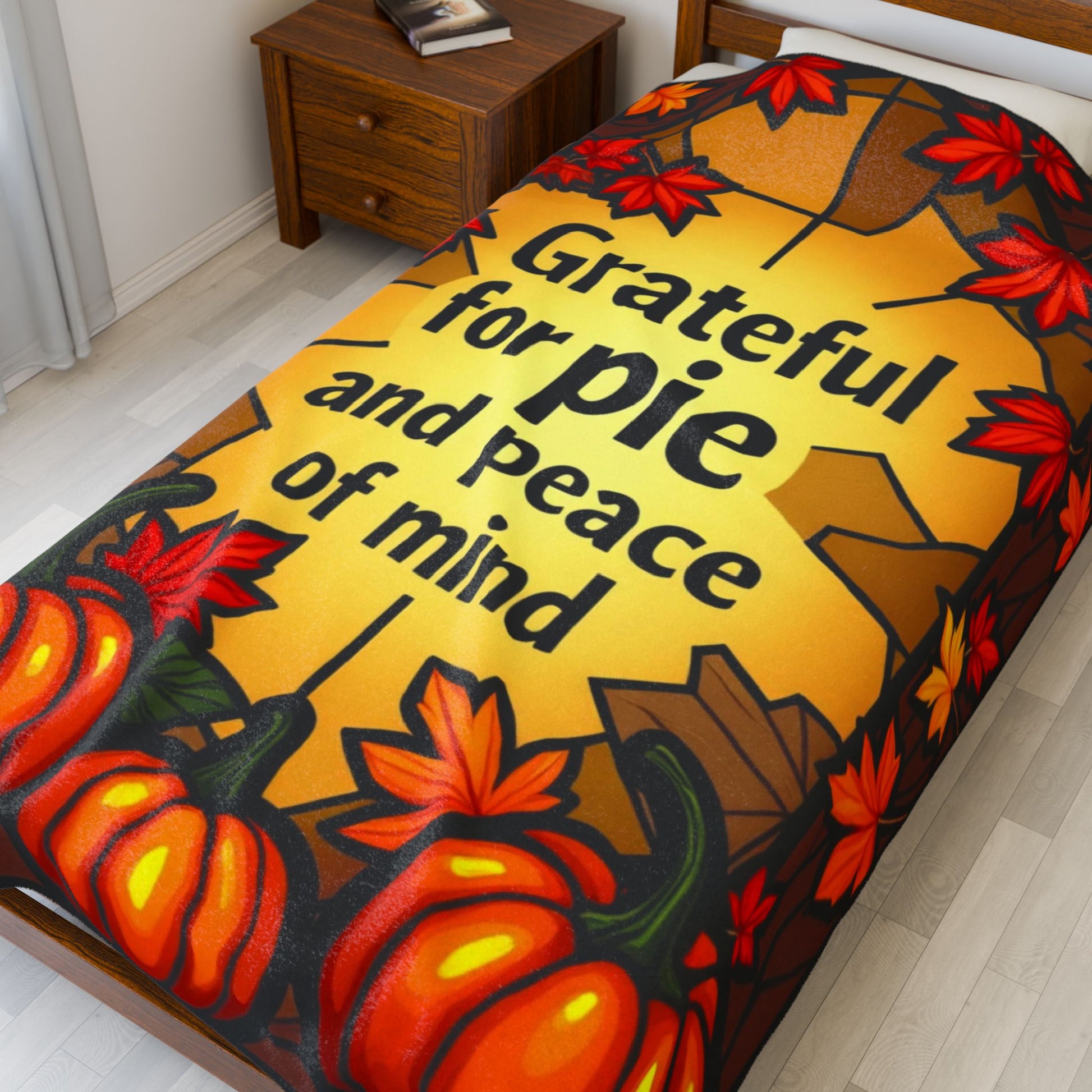 Thanksgiving blanket with “Grateful for Pie and Peace of Mind,” cheerful fall colors and cozy pie art.