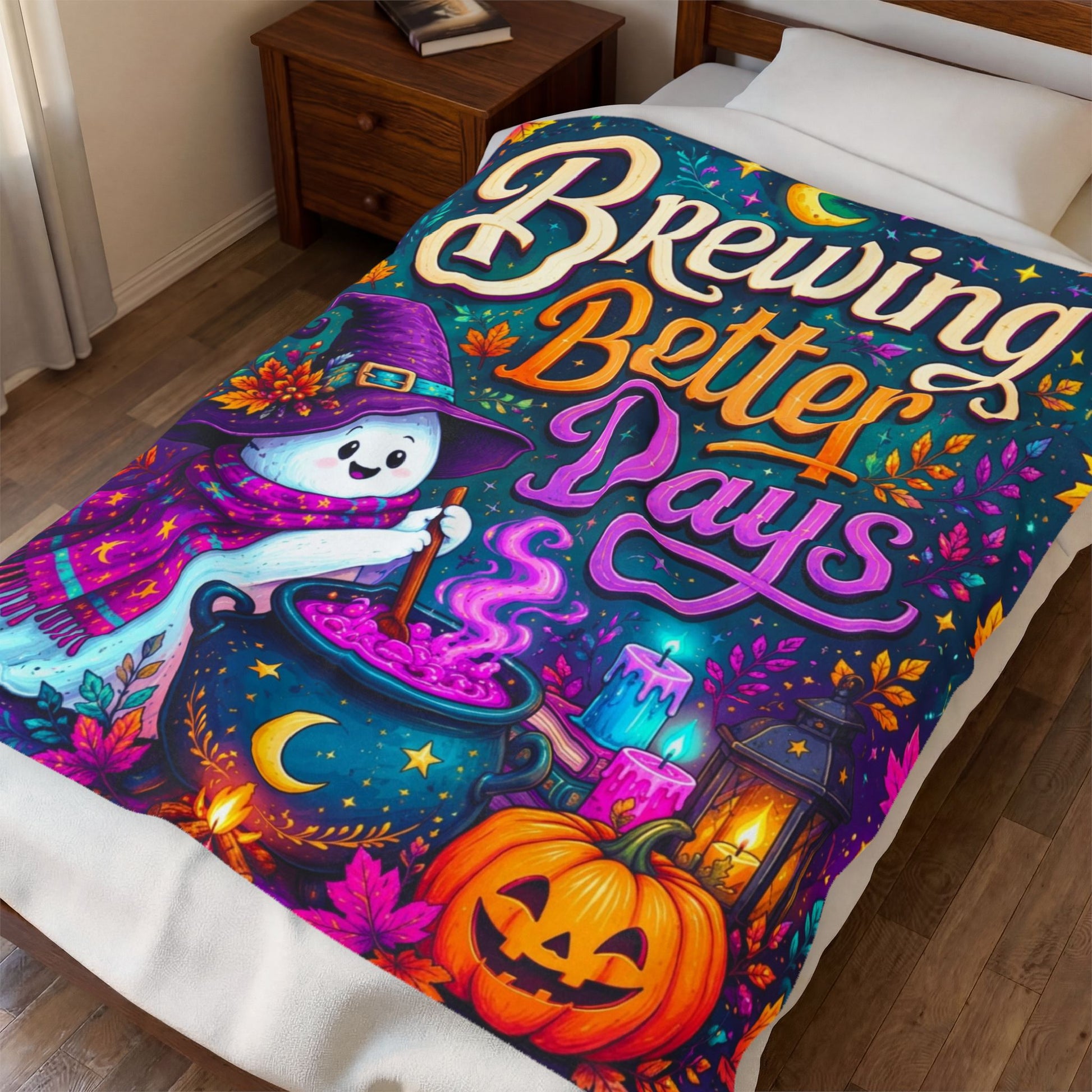 A colorful Halloween-themed blanket on a bed in a bedroom, featuring a printed blanket with the phrase 'Brewing Better Days' and a whimsical witch, cauldron, pumpkin, and lantern design.