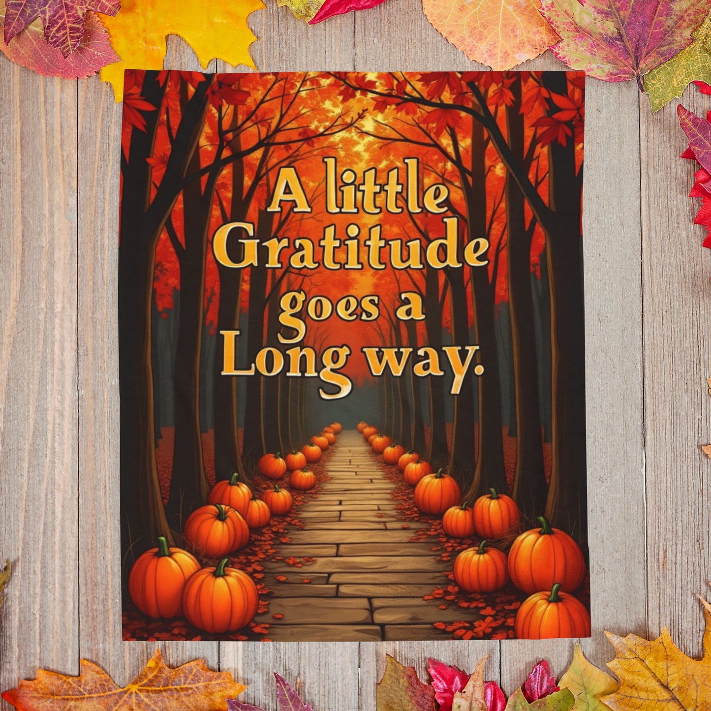 Soft fall blanket with quote “A Little Gratitude Goes a Long Way,” cozy autumn mindfulness design in warm tones.