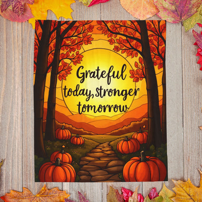 Motivational blanket with “Grateful Today, Stronger Tomorrow,” positive fall mindfulness message.