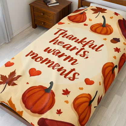 Thanksgiving blanket reading “Thankful Hearts, Warm Moments,” cozy autumn gratitude design.