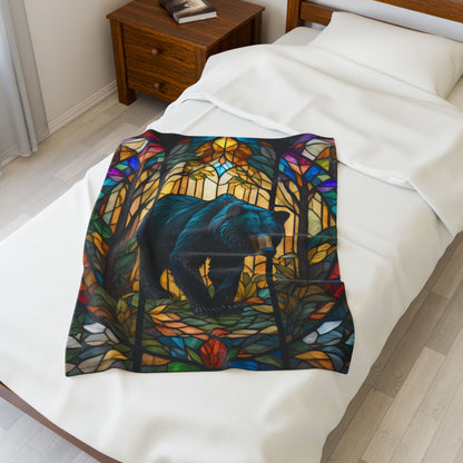 A cozy stained glass bear blanket featuring vibrant wildlife art for warmth and relaxation.