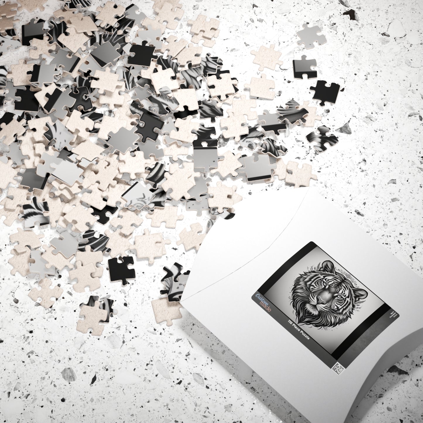 Jigsaw puzzle with black and white pieces on a light surface, next to an iPad displaying a tiger illustration.