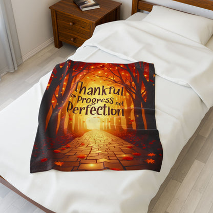 Mindful motivation blanket with “Thankful for Progress, Not Perfection,” calming fall color palette.