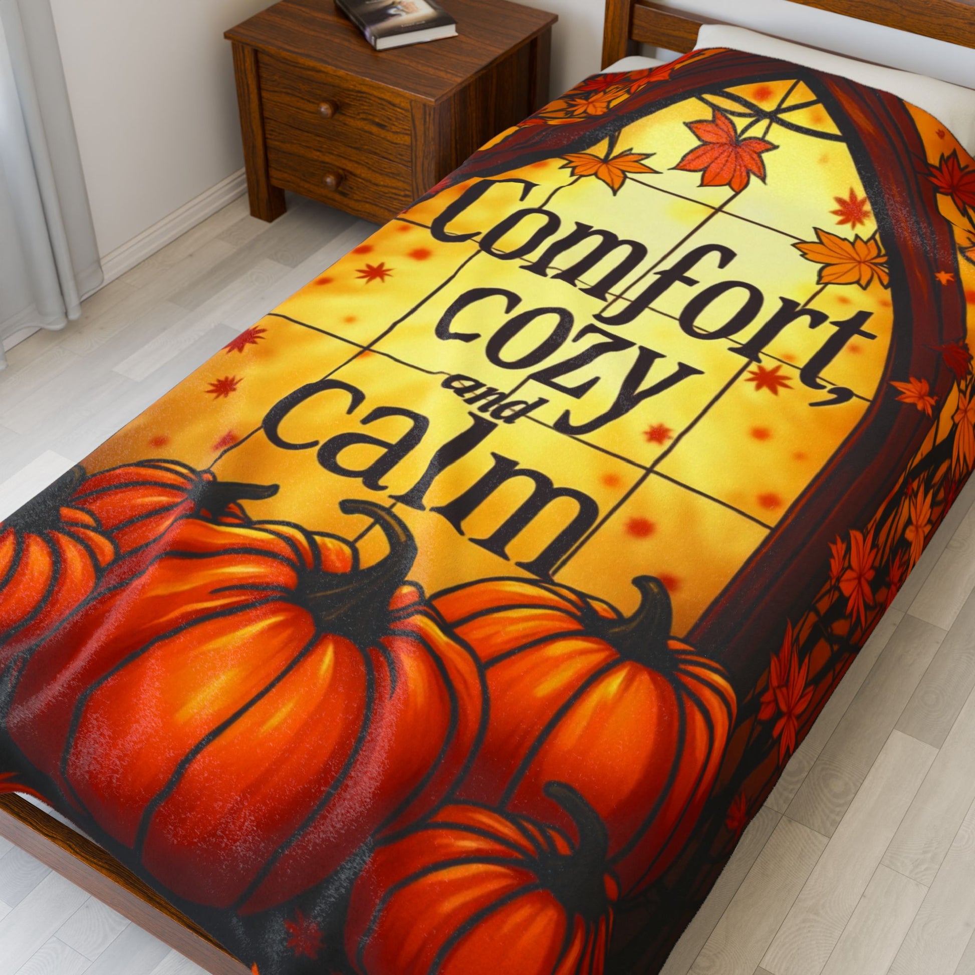 Velveteen blanket reading “Comfort, Cozy, and Calm,” relaxing fall self-care design in soft warm tones.