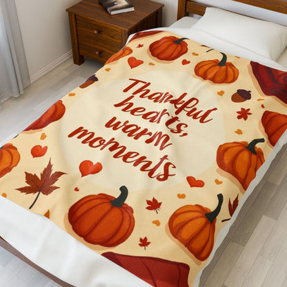 Thanksgiving blanket reading “Thankful Hearts, Warm Moments,” cozy autumn gratitude design.