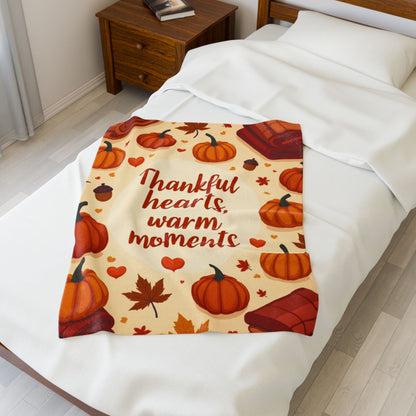 Thanksgiving blanket reading “Thankful Hearts, Warm Moments,” cozy autumn gratitude design.