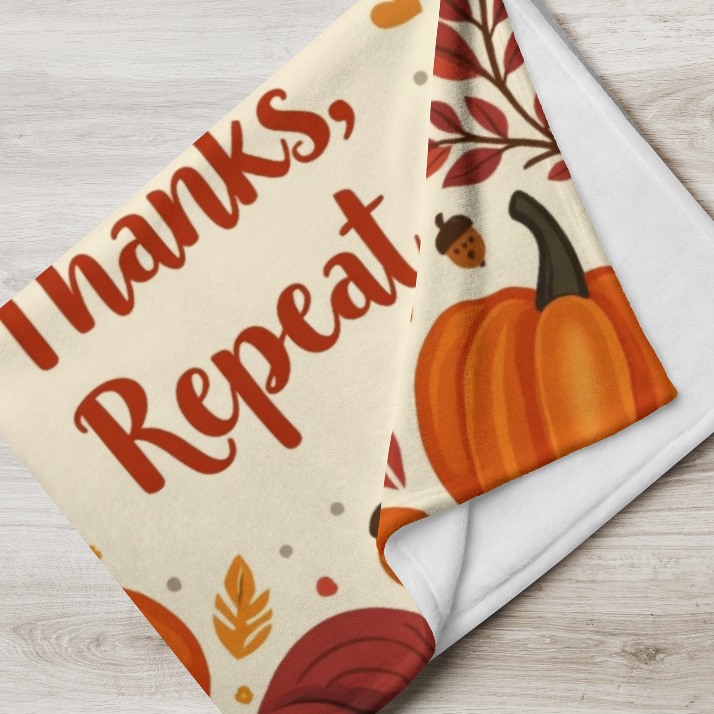 Cozy blanket with “Breathe, Give Thanks, Repeat,” autumn mindfulness theme in orange and gold hues.