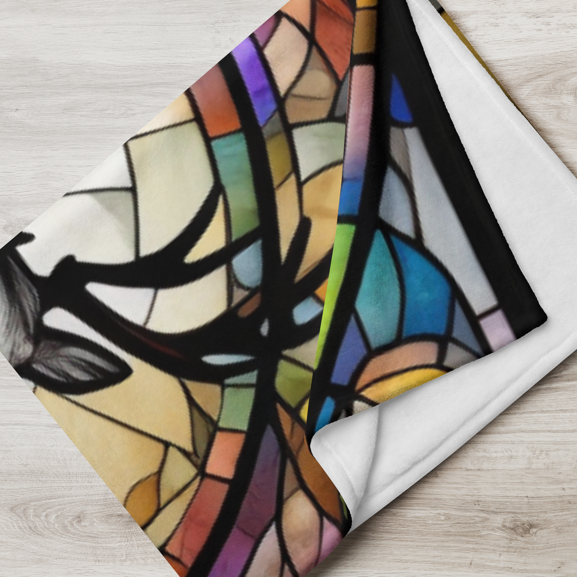 A reindeer blanket with stained glass-style art that adds warmth and festive woodland flair.
