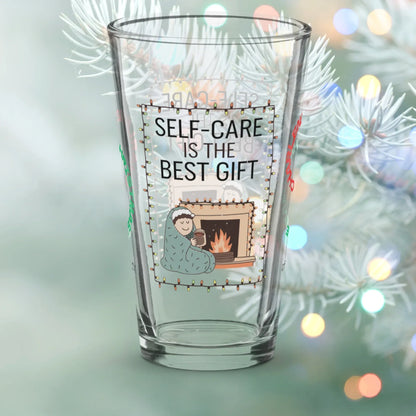 Shop our self care is the best gift christmas pint glass 1 featuring the 16oz style option from MySisterIsASurvivor.