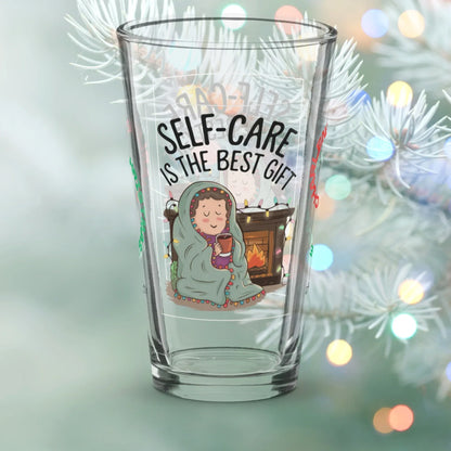 Shop our self care is the best gift christmas pint glass featuring the 16oz style option from MySisterIsASurvivor.