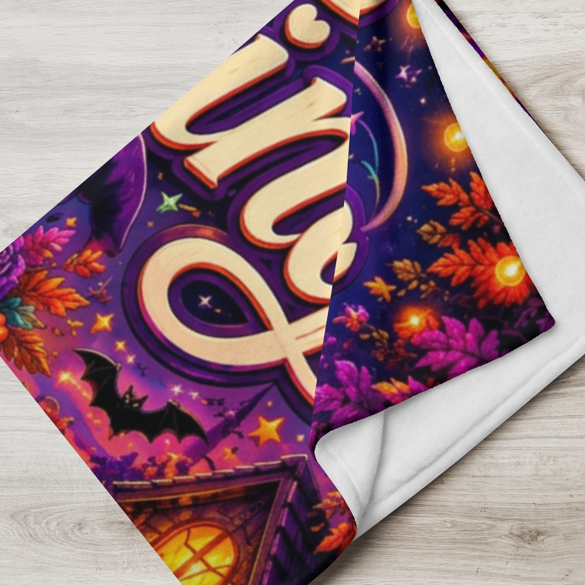A rectangular Halloween-themed blanket displayed against a light wood plank background. The artwork features the words 'Ghosting Negative Vibes' in large decorative lettering, with a cartoon ghost wearing a witch hat and sunglasses, surrounded by pumpkins, a moonlit sky, a house, and lanterns.