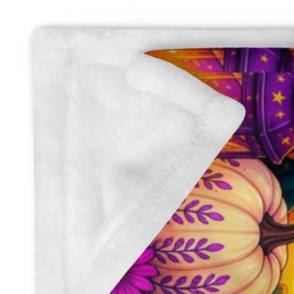 A colorful Halloween-themed blanket with the phrase “Treat Yourself Kindly” in large decorative lettering. The scene shows a smiling ghost in a witch hat holding a mug, surrounded by pumpkins, flowers, a house, candles, and autumn leaves on a purple background.