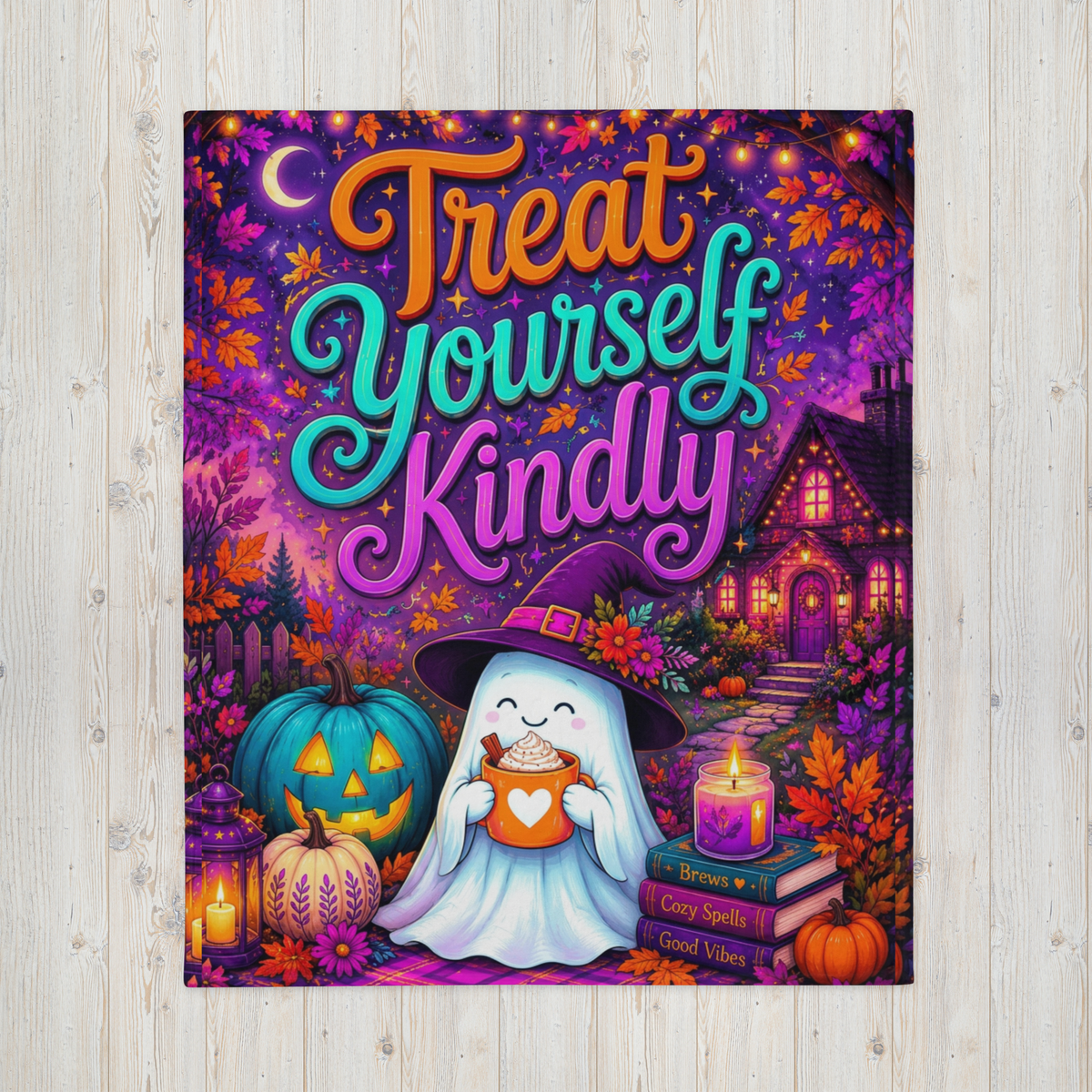 A colorful Halloween-themed blanket with the phrase “Treat Yourself Kindly” in large decorative lettering. The scene shows a smiling ghost in a witch hat holding a mug, surrounded by pumpkins, flowers, a house, candles, and autumn leaves on a purple background.