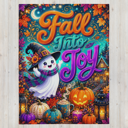 A colorful Fall Into Joy Halloween blanket featuring a cute ghost in a witch hat and scarf, surrounded by pumpkins, lanterns, and autumn leaves, displayed on a light wood background.