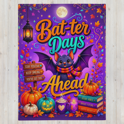 A colorful Halloween-themed blanket featuring a cute cartoon bat with wings, surrounded by pumpkins, autumn leaves, a lantern, and the phrase “Bat-ter Days Ahead.” The background is purple with swirling decorative lines and stars.