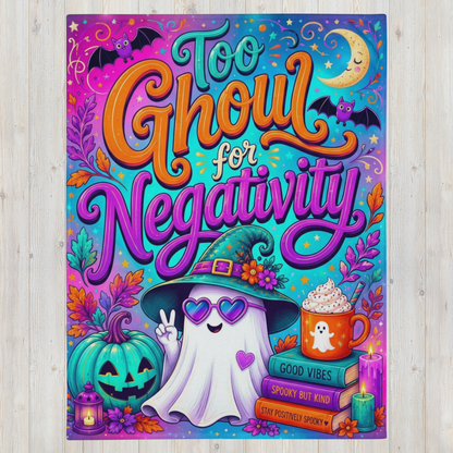 A colorful Halloween-themed blanket with the phrase 'Too Ghoul for Negativity' in large stylized lettering. The design features a smiling ghost wearing a witch hat, a jack-o'-lantern, a mug of hot chocolate, candles, bats, a crescent moon, and autumn leaves on a bright multicolor background, shown against a light wood surface.