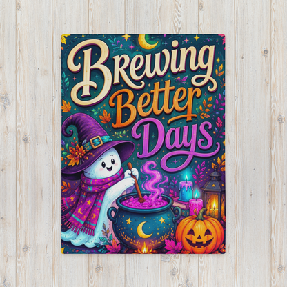 A Halloween blanket with the phrase “Brewing Better Days” in large decorative lettering, featuring a cartoon ghost in a purple witch hat stirring a cauldron, with candles, a lantern, autumn leaves, and a jack-o'-lantern on a dark patterned background.