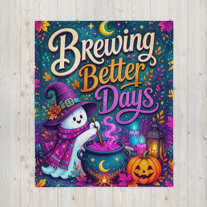 A rectangular blanket featuring a colorful Halloween-themed illustration with the phrase “Brewing Better Days” in large decorative lettering. The artwork shows a white ghost in a purple witch hat and scarf stirring a cauldron, with a glowing moon, candles, lantern, jack-o'-lantern, and autumn leaves on a dark teal background.