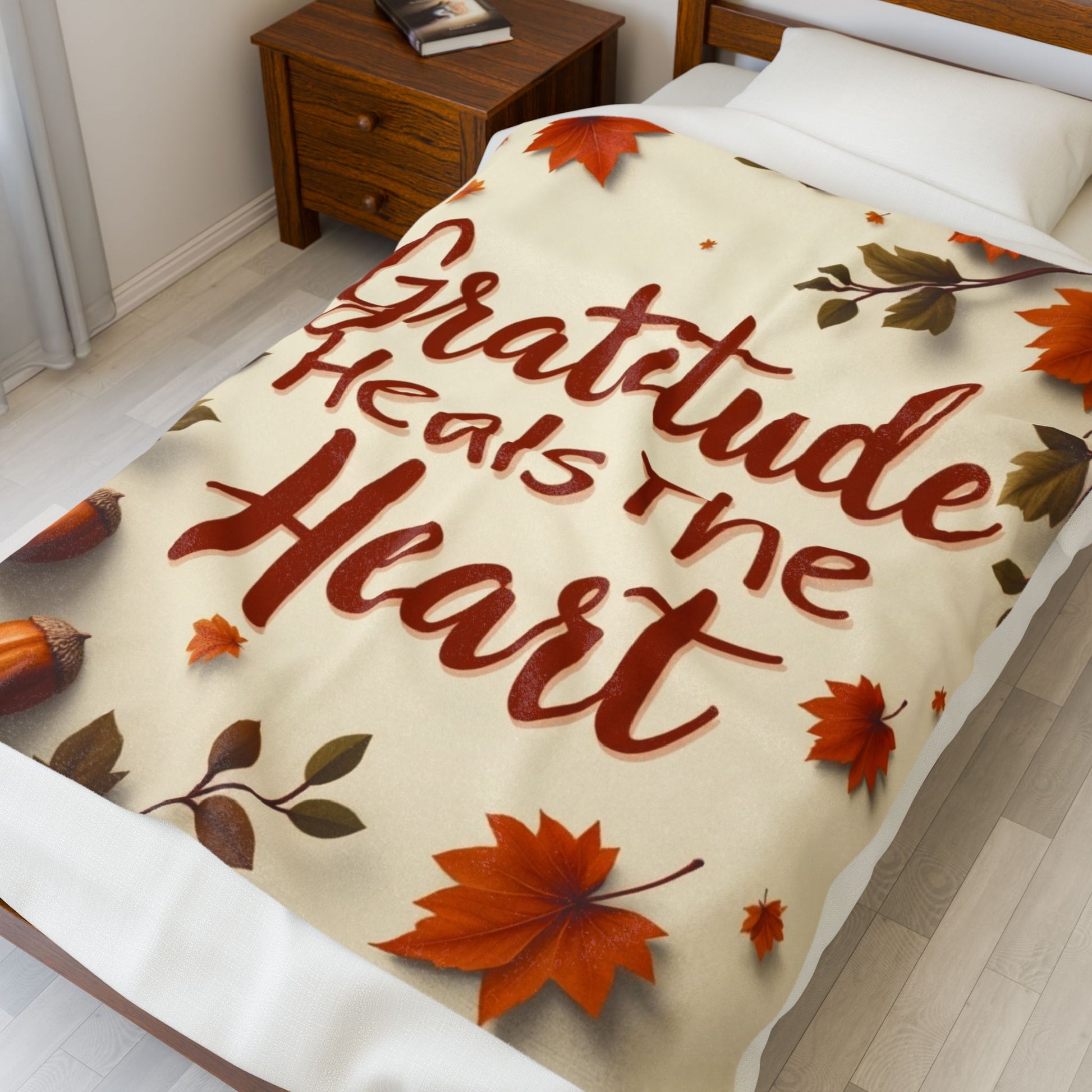 Cozy blanket reading “Gratitude Heals the Heart,” autumn mindfulness design promoting warmth and peace.
