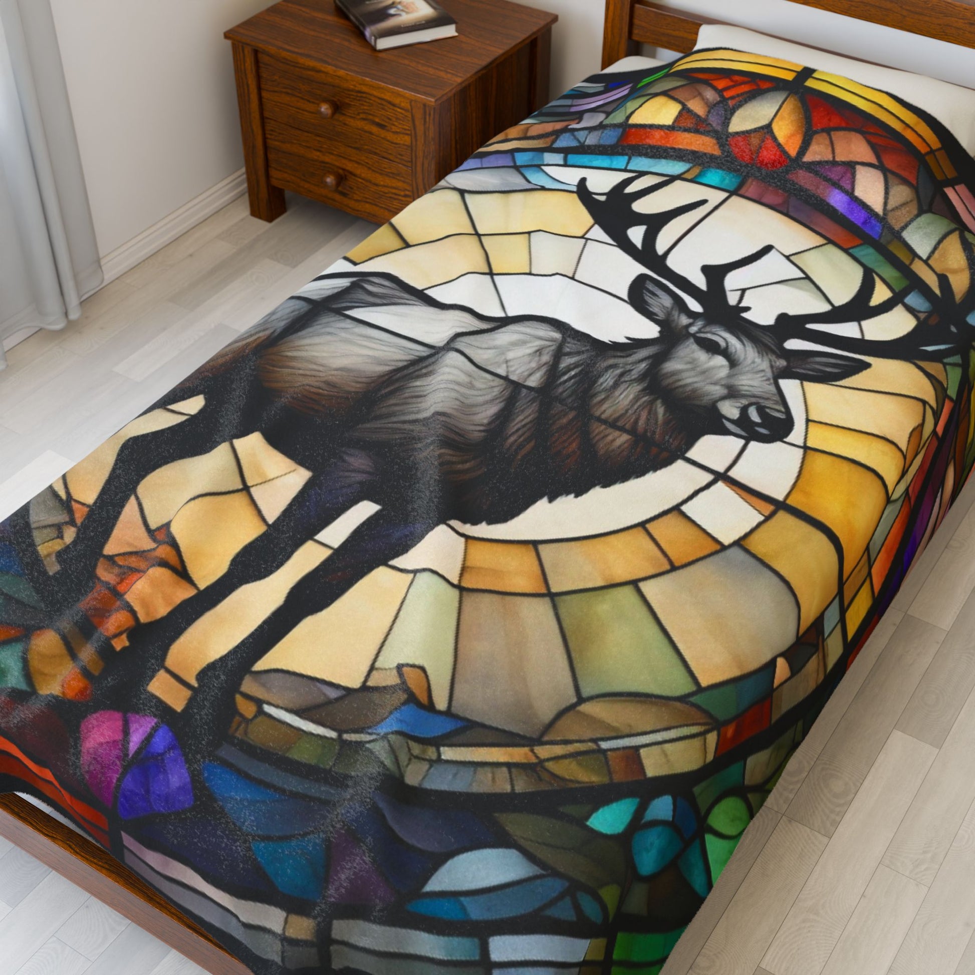 A reindeer blanket with stained glass-style art that adds warmth and festive woodland flair.