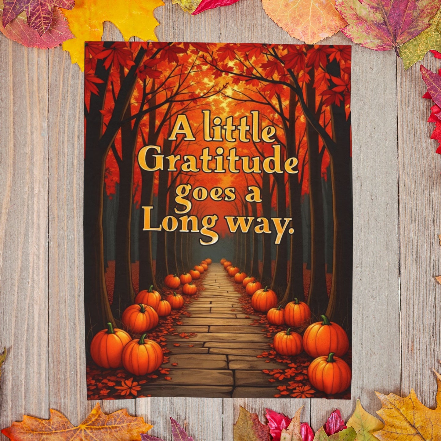 Soft fall blanket with quote “A Little Gratitude Goes a Long Way,” cozy autumn mindfulness design in warm tones.