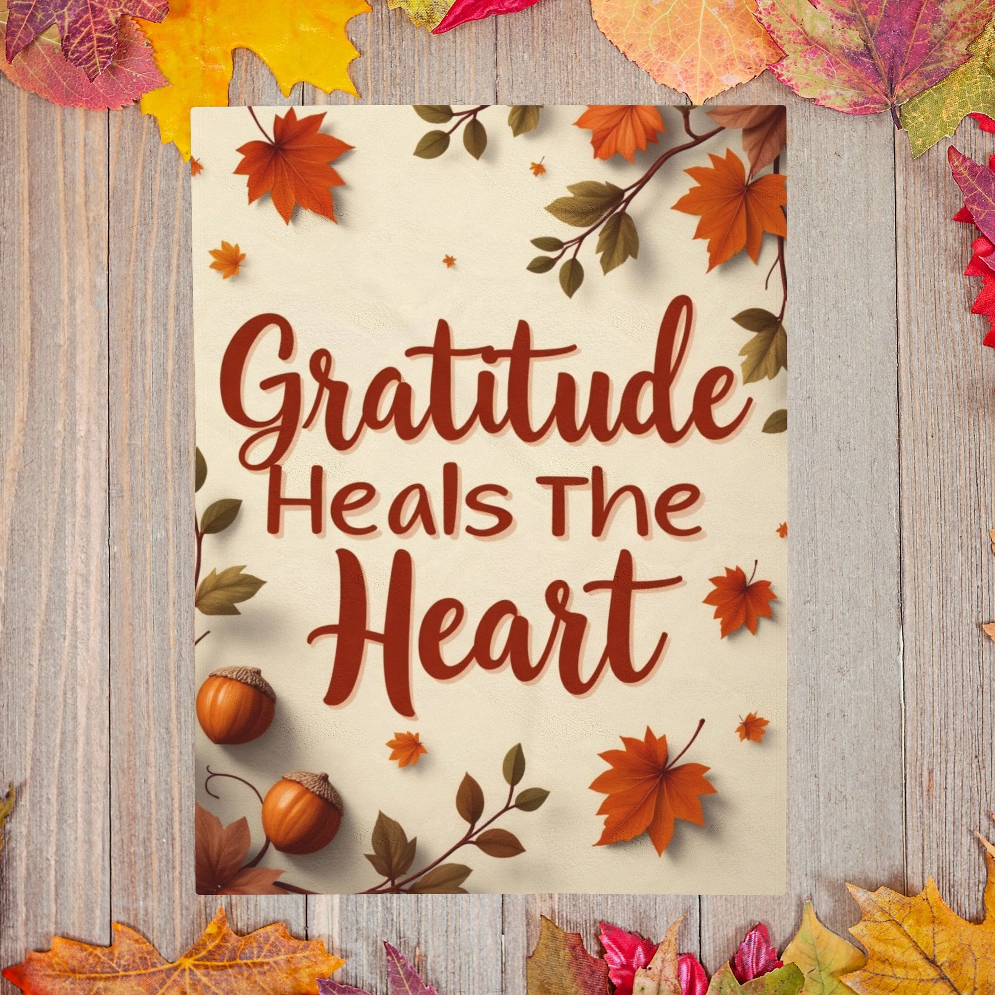 Cozy blanket reading “Gratitude Heals the Heart,” autumn mindfulness design promoting warmth and peace.