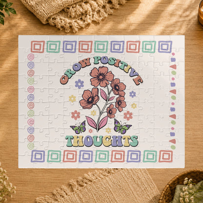 Jigsaw puzzle with floral design and 'Grow Positive Thoughts' text on a white background