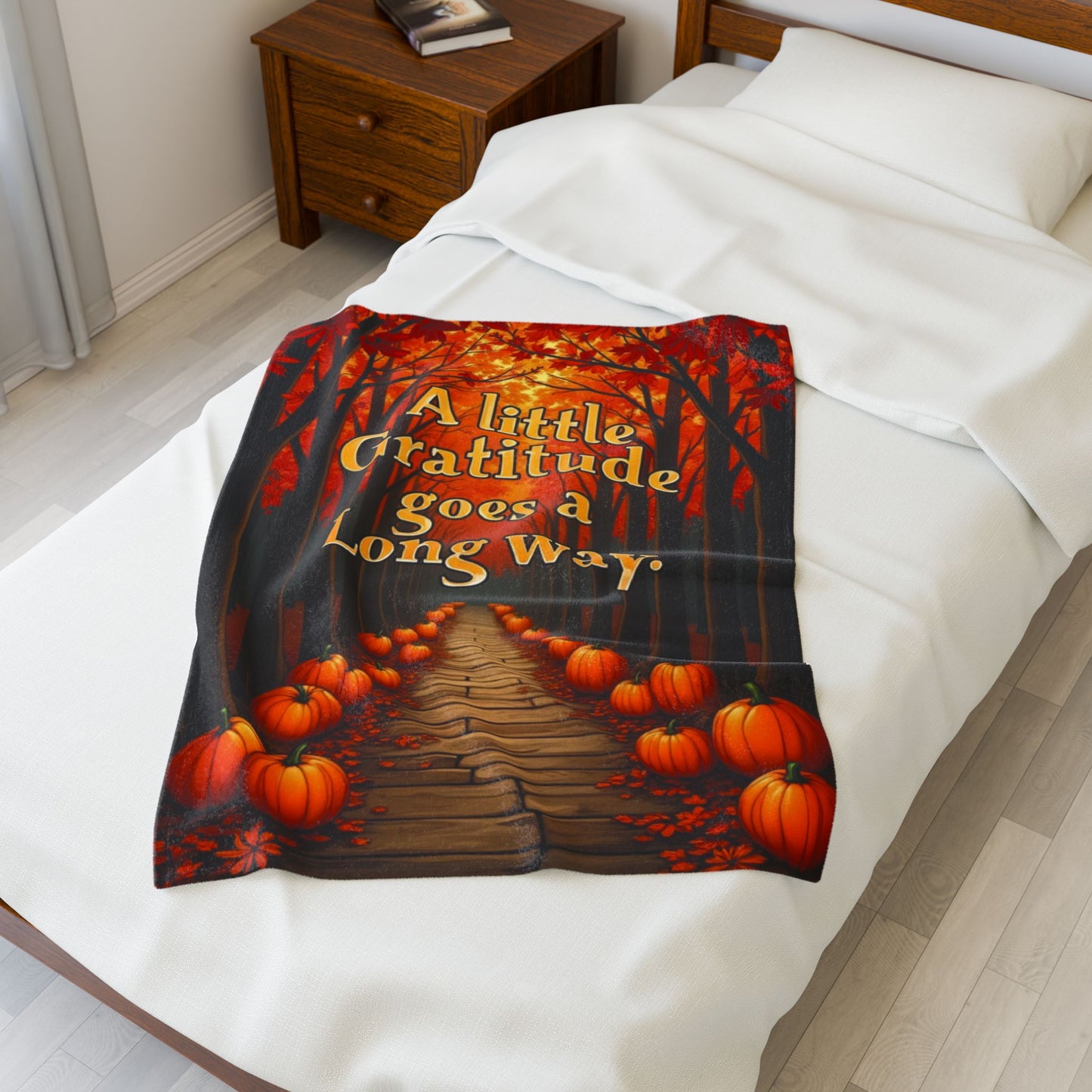 Soft fall blanket with quote “A Little Gratitude Goes a Long Way,” cozy autumn mindfulness design in warm tones.