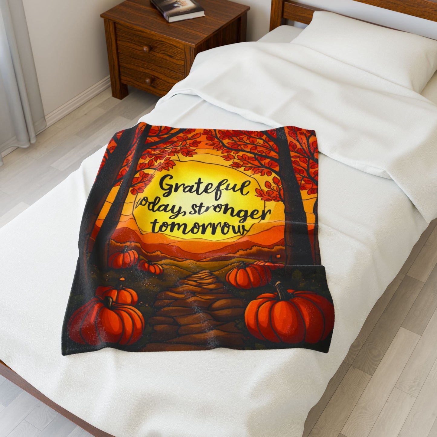 Motivational blanket with “Grateful Today, Stronger Tomorrow,” positive fall mindfulness message.