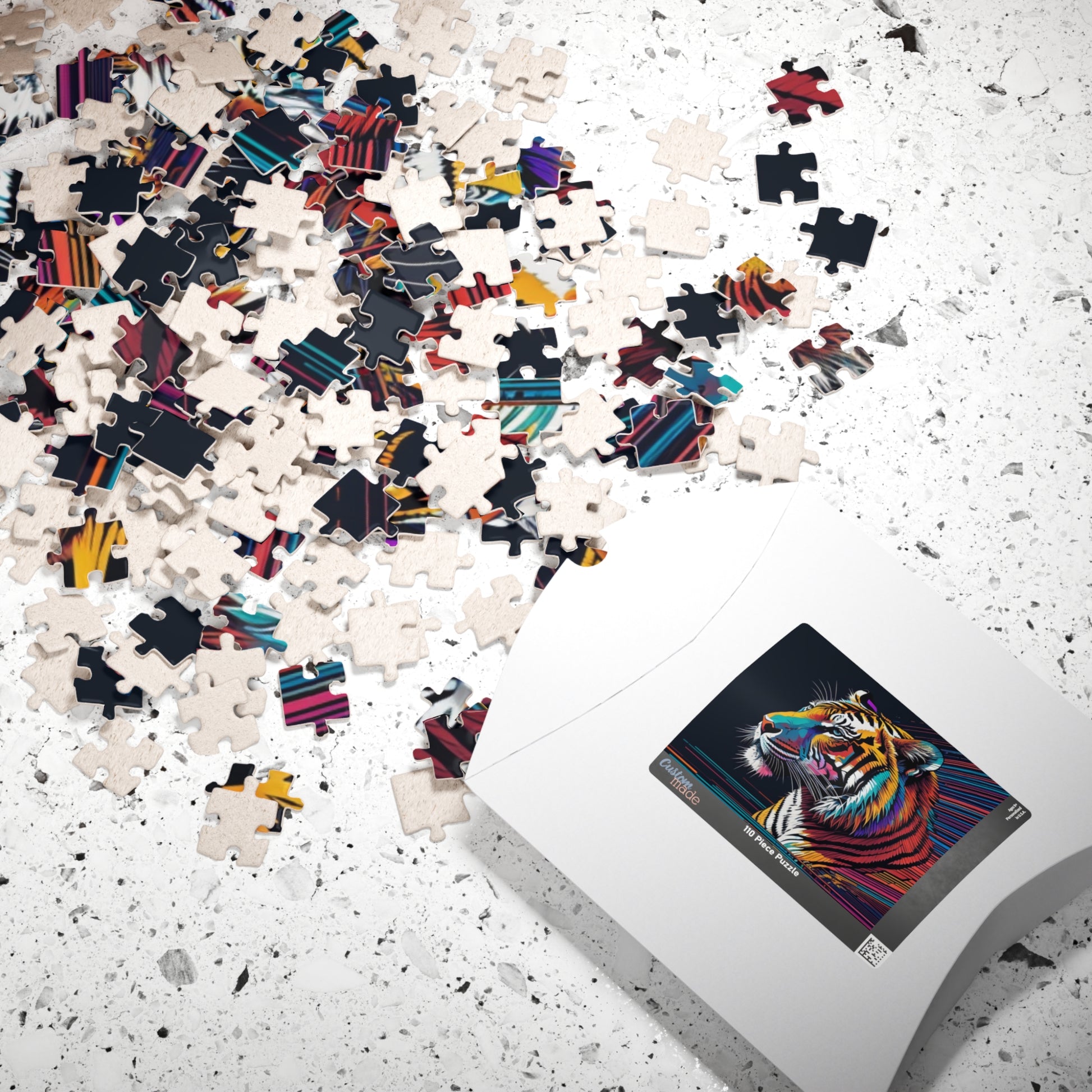 Jigsaw puzzle with colorful tiger design on a partially completed puzzle and box on a speckled surface.