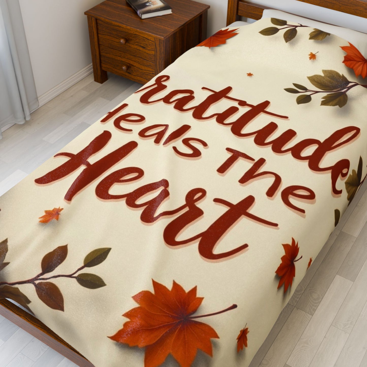 Cozy blanket reading “Gratitude Heals the Heart,” autumn mindfulness design promoting warmth and peace.