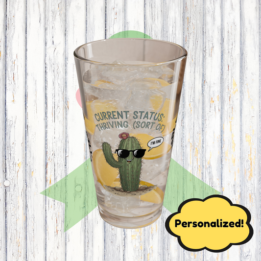 "Current Status: Thriving (Sort Of)" personalized funny pint glass with attitude and daily humor.