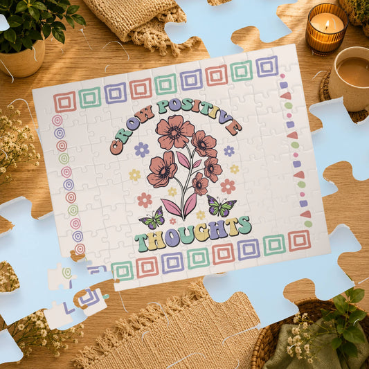 Jigsaw puzzle with a motivational design on a wooden table with plants and a cup.