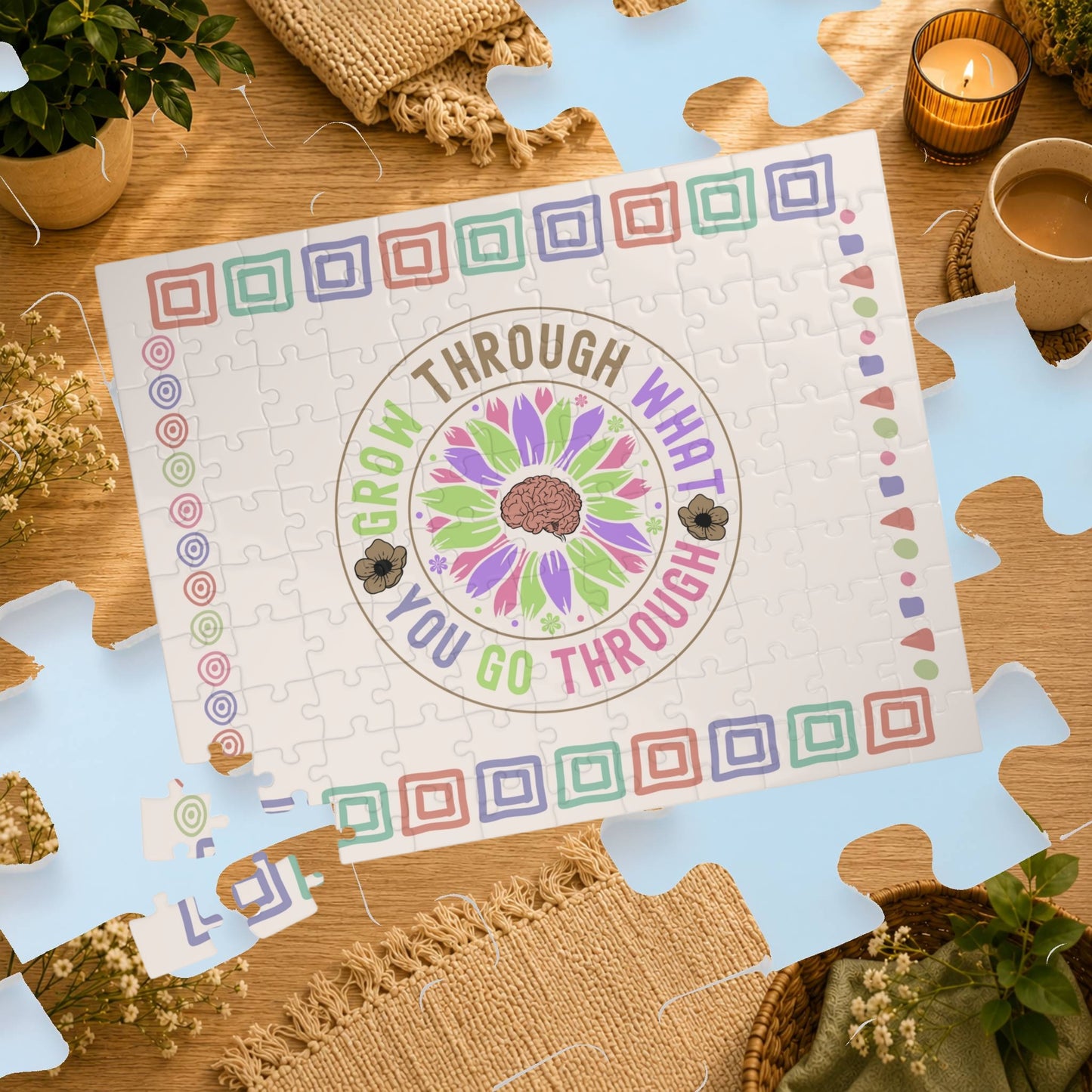 Jigsaw puzzle with motivational quote on a wooden table with decorative items.