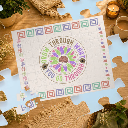 Jigsaw puzzle with motivational quote on a wooden table with decorative items.