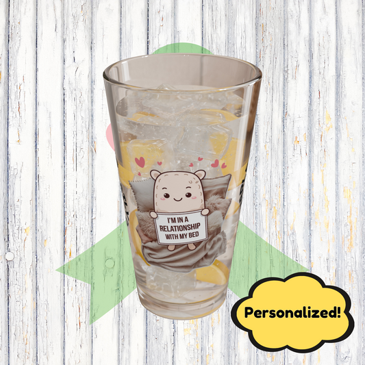 "I’m In A Relationship With My Bed" personalized funny pint glass for cozy moments and relaxation.