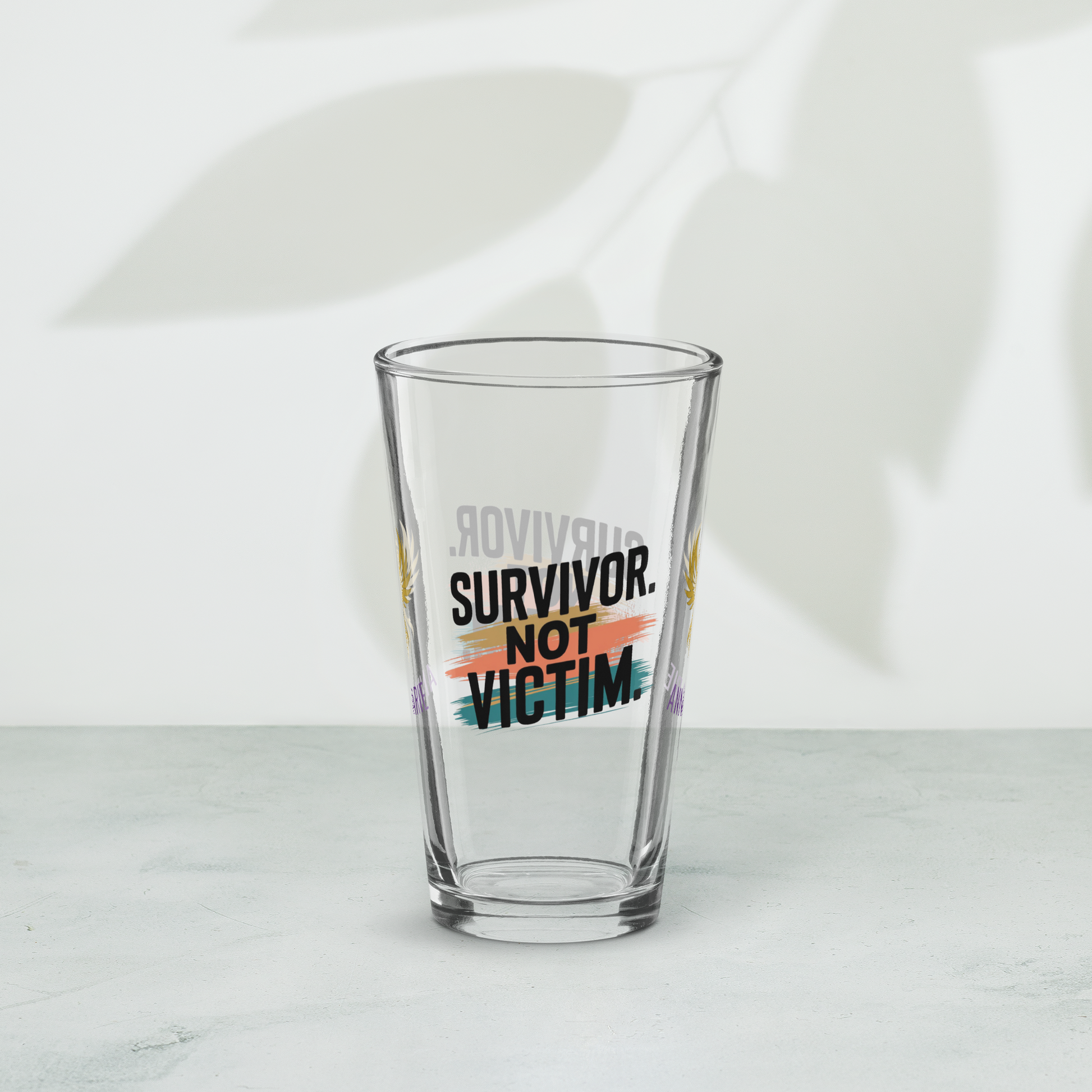 Survivor Not Victim pint glass, empowering quote design, trauma recovery awareness gift