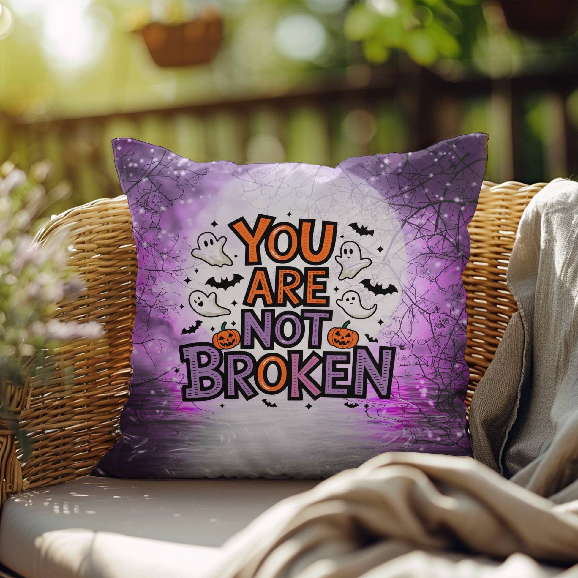 Indoor/outdoor pillow with “You Are Not Broken” for mental health awareness