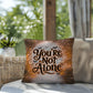 Indoor/outdoor mental health pillow with “You’re Not Alone” to promote comfort and support