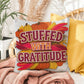 Stuffed With Gratitude throw pillow featuring Thanksgiving quote and warm fall seasonal décor accent