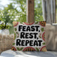 Feast, Rest, Repeat pillow featuring mindfulness message with cozy Thanksgiving and fall décor vibes